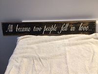 Full view of wooden quote sign