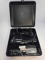 Mixer, cord, attachments inside open storage case