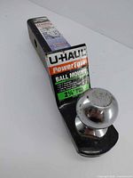 Overall view of U-Haul ball mount hitch with label and chrome ball visible
