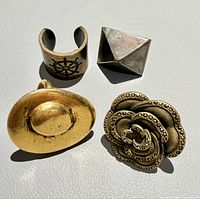 Four costume rings arranged on surface