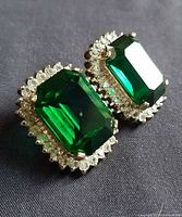 Front view showing green emerald-cut center stones with clear rhinestone borders