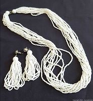 Necklace and pair of earrings laid out to show full set