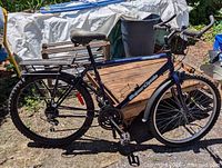 Left side full view of Supercycle Breeze bicycle showing overall condition, frame, wheels, and accessories