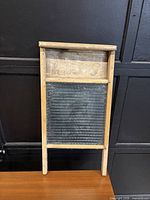 Front view showing wooden frame, glass surface, advertising panel