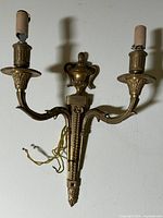 Front view of gilded bronze two-arm wall sconce