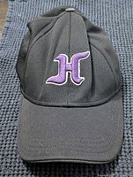 Front view showing purple embroidered H logo, curved brim