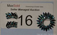 Photo of the matching brooch and clip-on earrings set showcasing blue and green rhinestones