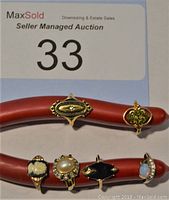 Six women’s rings displayed on red ring stand
