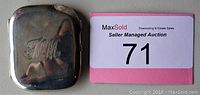Closed view of rectangular silver cigarette case monogrammed 'M M'