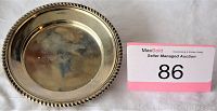 Photo showing the round silver tray with twisted rope detail edge and auction number card.