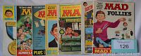 Photo of seven MAD Special Edition magazines from the 1960s with visible colorful covers and titles