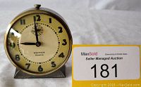 Front view of the vintage Westclox America alarm clock showing the clock face, numerals, hands, and brand name.