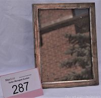 Vintage rectangular picture frame with sterling silver outer border and wood inner frame, showing some small dents and patina.
