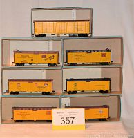 Seven HO gauge Athearn railroad box cars displayed in original boxes, various railroad markings visible