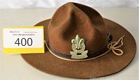Brown felt Boy Scout official Stetson hat with leather band and Boy Scout emblem badge on front, shown on white background with MaxSold lot card.