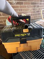 Front view showing Ridgid Pro Pack 5.0 HP label, handle, hose and cord