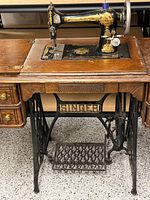 Full view of machine in cabinet showing base, drawers, and foot pedal