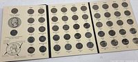 Tri-fold album opened showing all quarters