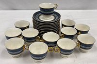 Full set showing 12 cups and stack of 12 saucers