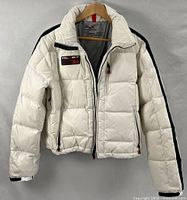 Front view of white RLX down jacket on hanger
