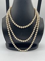 Necklace draped on bust to show layering length
