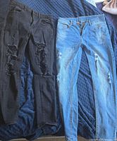 Both pairs of jeans laid flat side by side