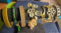 Front view of six bracelets on display stand