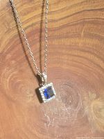 Full view of necklace on wood background