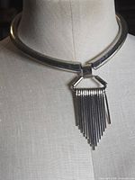 Necklace on mannequin showing front pendant and collar