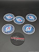 Five coasters laid out showing logos