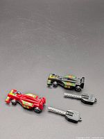 Overall view of two toy race cars and two keys