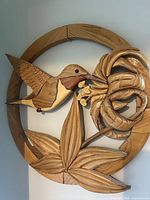 front view of intact round wooden hummingbird floral wall art