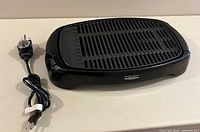 Electric grill with power cord displayed
