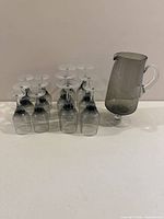 pitcher with inverted wine glasses arranged beside