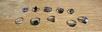 Group shot of eleven sterling silver rings with assorted gemstones and bands