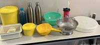 Full lot overview on tabletop showing all kitchenware and drinkware pieces