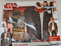 Front view of boxed Poe Dameron costume showing jacket, shirt, belt and Star Wars branding