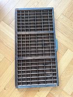 Front view showing full compartment grid of wooden printer tray