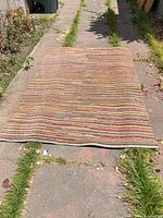 Full view of entire area rug laid flat showing overall size and stripe pattern