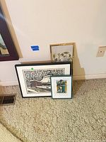 Three framed pieces: Nishijima print, watercolor, needlepoint