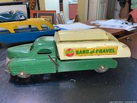 Left side view showing Buddy L Sand and Gravel decal, green cab, cream dump bed