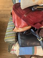 Stack of mixed leather and fabric purses