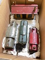 Three locomotives and station in packing box