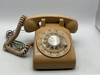 Front view showing rotary dial, handset, coiled cord