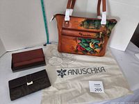 All items: Anuschka shoulder bag, two wallets, dust bag