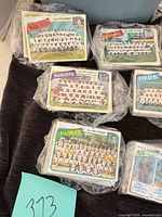 Multiple plastic-wrapped stacks of Topps team photo cards including Red Sox, Rangers, Padres, Dodgers, Reds visible