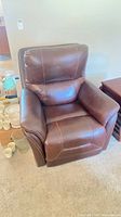 Front view of dark brown leather electric recliner armchair