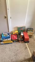 Group shot of all boxed games, puzzles and slot machine bank