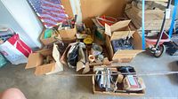 Overview of six boxes with assorted tools, cords, polisher, caulking guns