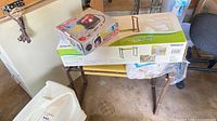 Boxed Bel Air tire inflator atop boxed Gardenline kneeler seat and assembled matching bench